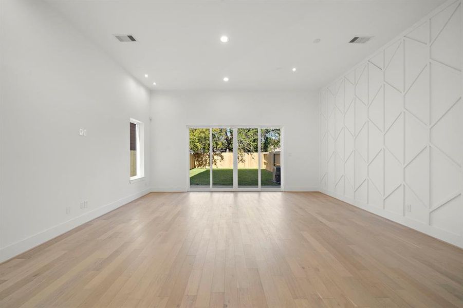 Living/dining area with 12-foot ceilings, great natural light, and an oversized backyard, perfect for entertaining. (Photo is of a previously completed home.)