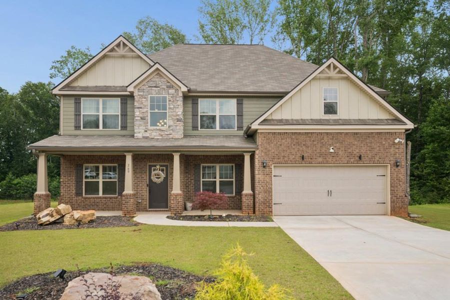 Front exterior of a new home in Nine Oaks, Locust Grove, GA, highlighting curb appeal (Image 24). Front exterior of a new home in Nine Oaks, Locust Grove, GA, highlighting curb appeal (Image 24).