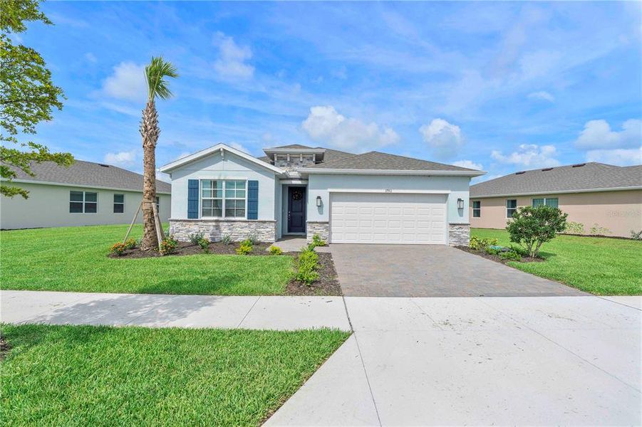 Front exterior of a new home in Palmetto Landing at Babcock Ranch - Tradition, Punta Gorda, FL, highlighting curb appeal (Image 2).