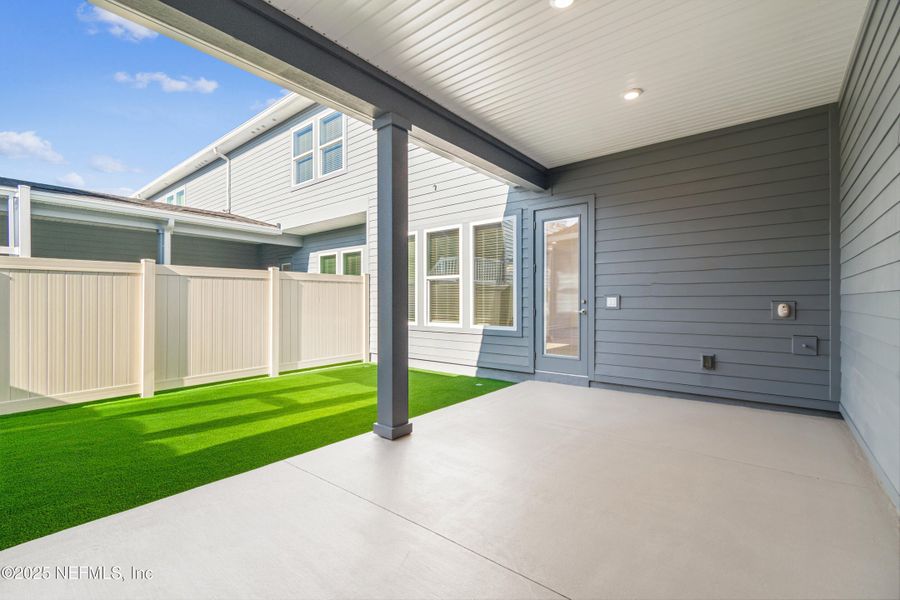 Exterior details and patio area of a home in Seven Pines 24' Rear Entry Townhomes, Jacksonville (Image 3).