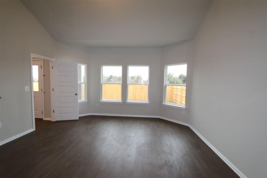 Empty room featuring dark hardwood / wood-style floors