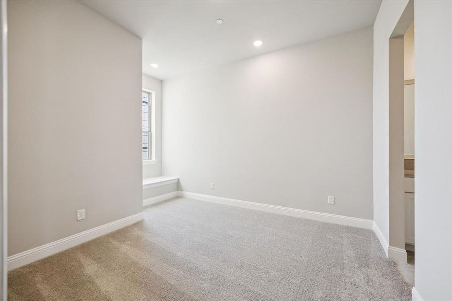 Secondary bedroom with window seat. Secondary bedroom with window seat.