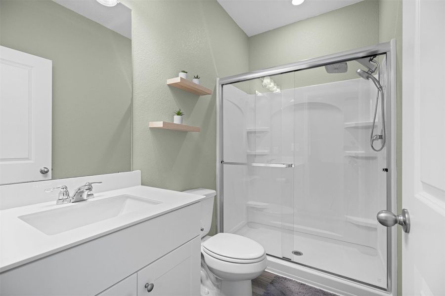 Bathroom with vanity and a shower stall Bathroom with vanity and a shower stall