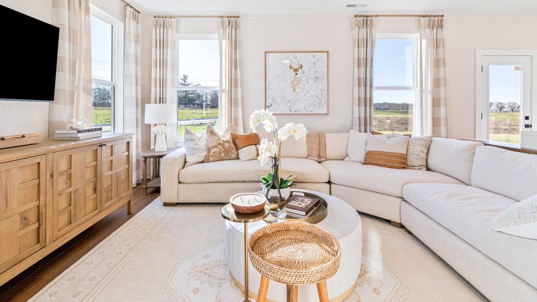 Gathering room with hard surface flooring, ceiling fan, and windows