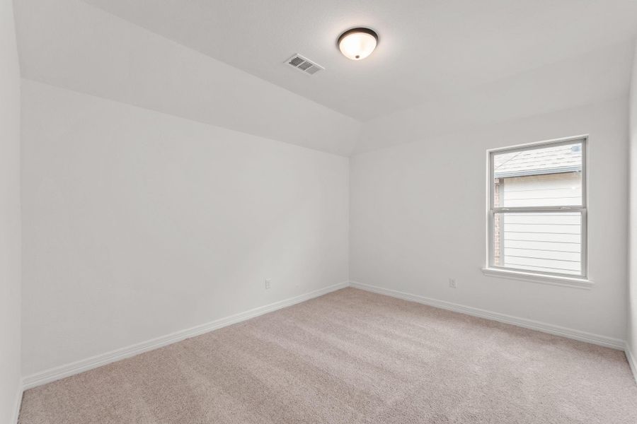 Your secondary bedroom features plush carpet, fresh paint, closet, and a large window that lets in plenty of natural lighting.