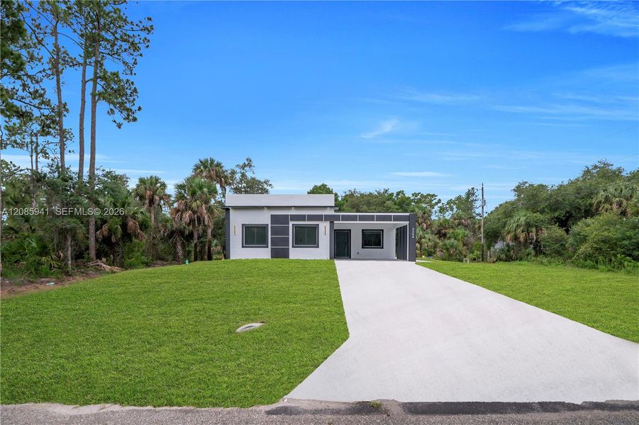 Front exterior of a new home in , Lehigh Acres, FL, highlighting curb appeal (Image 25). Front exterior of a new home in , Lehigh Acres, FL, highlighting curb appeal (Image 25).