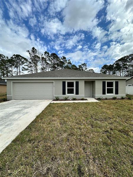 Front exterior of a new home in Palm Coast: Value Collection, Palm Coast, FL, highlighting curb appeal (Image 1).
