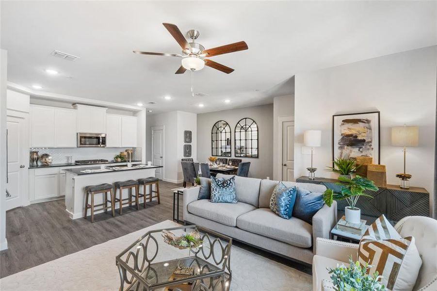 Living room featuring hardwood / wood-style floors and ceiling fan