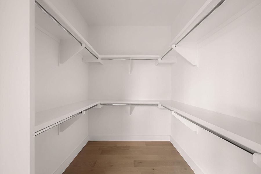 Walk in closet featuring light wood-type flooring Walk in closet featuring light wood-type flooring
