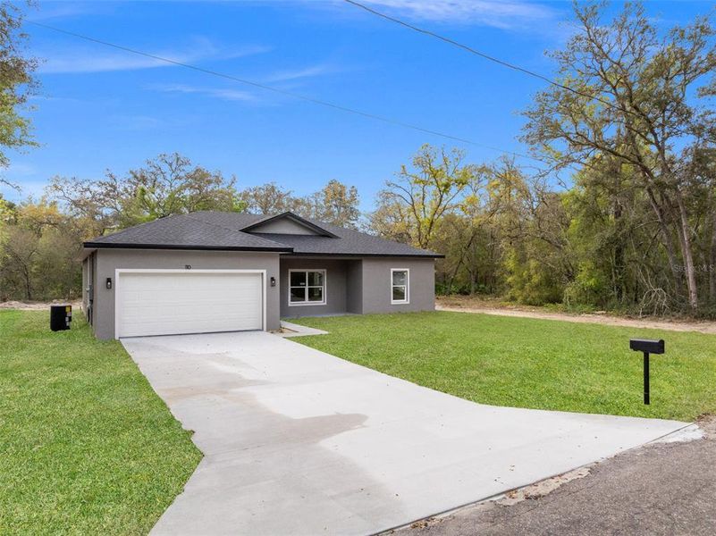 Front exterior of a new home in , Ocklawaha, FL, highlighting curb appeal (Image 19).