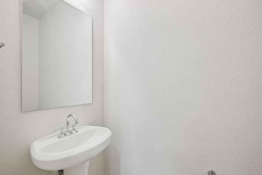 A bathroom with a mirror and sink.