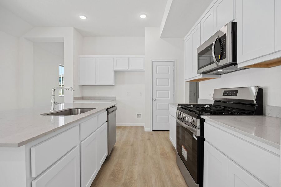 Kitchen in the Elm home plan by Trophy Signature Homes – REPRESENTATIVE PHOTO