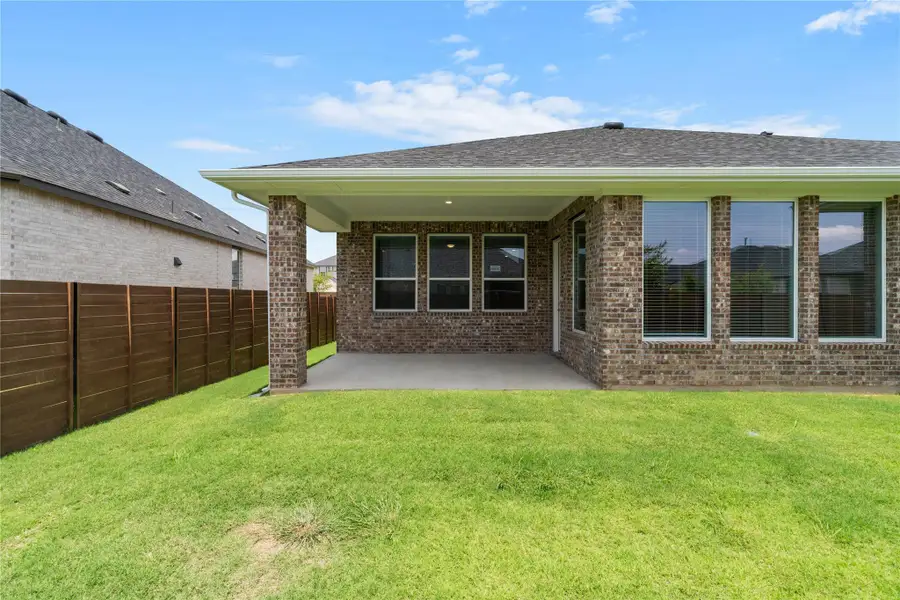 Enjoy outdoor living on this shaded rear patio overlooking a private grassy yard. Enjoy outdoor living on this shaded rear patio overlooking a private grassy yard.