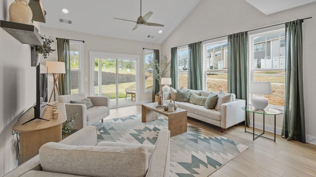Spacious family room with rich hardwood flooring and elegant trim work in a reputable DRB Homes build