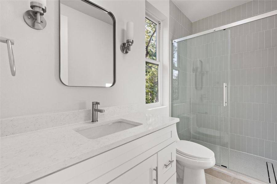 Bathroom with a stall shower and vanity