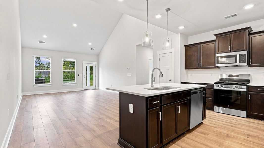 Well-designed kitchen with a center island and tasteful finishes that elevate everyday living at Village at Midway