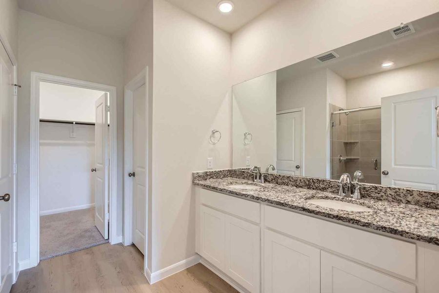 A bathroom with a marble countertop.