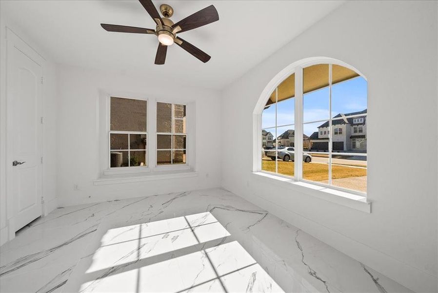In-law suite featuring natural light, marble floors and ceiling fan In-law suite featuring natural light, marble floors and ceiling fan