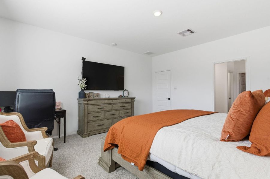 Spacious primary bedroom located on the first floor for comfort and privacy. Spacious primary bedroom located on the first floor for comfort and privacy.