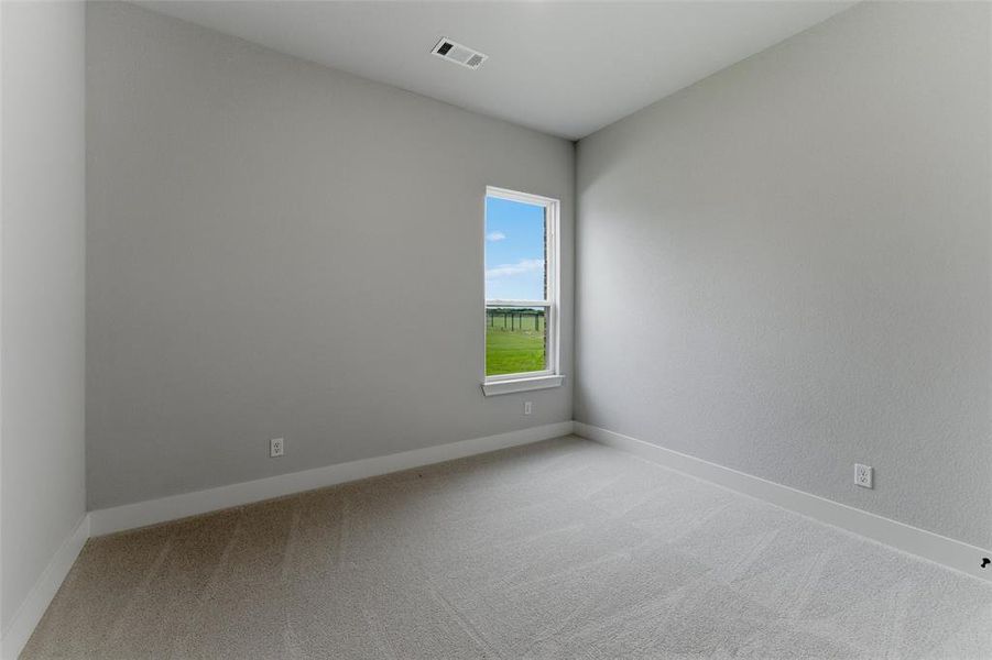 Carpeted room with light grey walls, a single window, and white baseboards