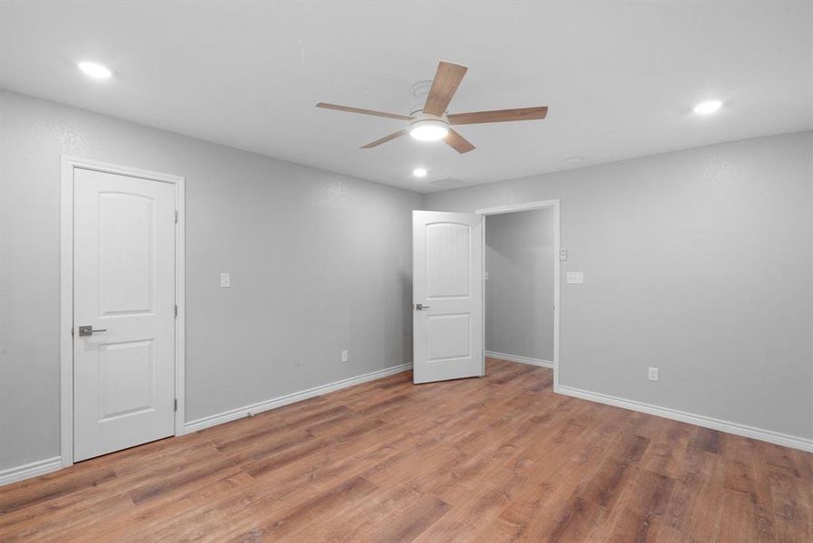 Spare room featuring hardwood / wood-style flooring and ceiling fan Spare room featuring hardwood / wood-style flooring and ceiling fan