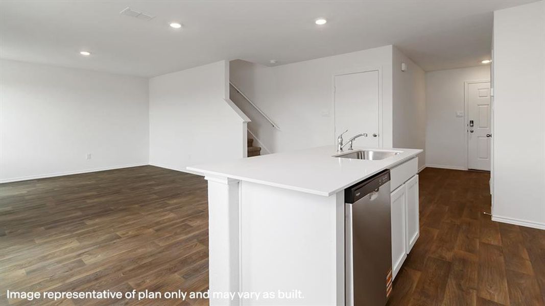 Kitchen featuring recessed lighting, dishwasher, dark wood finished floors, a kitchen island with sink, and white cabinetry