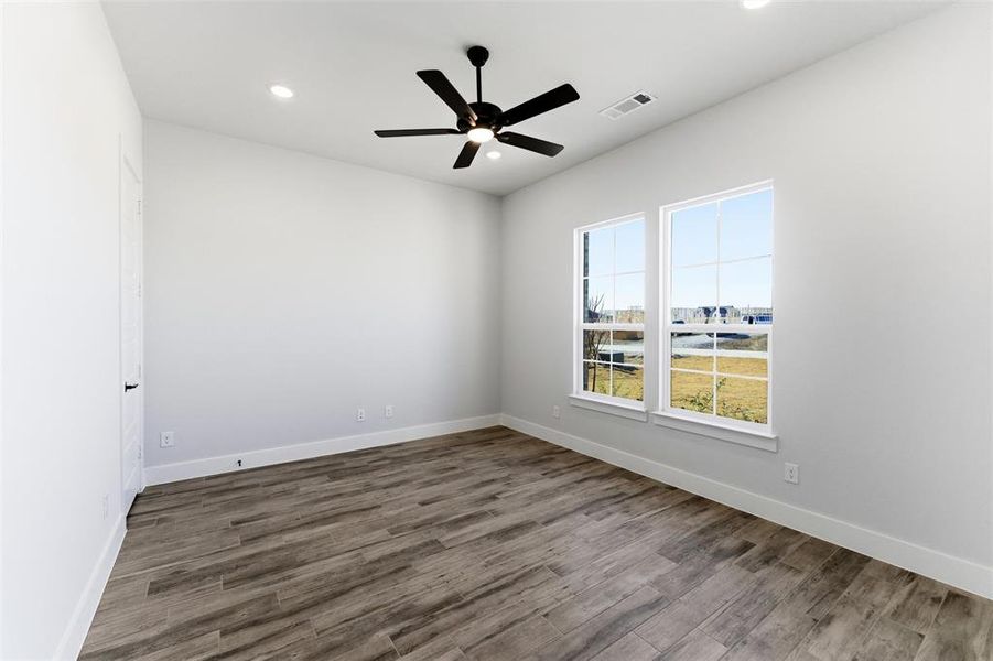 Unfurnished room featuring wood finished floors, ceiling fan, and recessed lighting