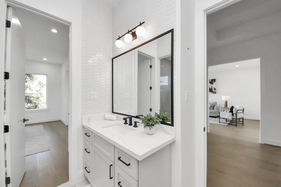 Bedroom 3 offers a bathroom with a vanity that can function as a powder bath for guests