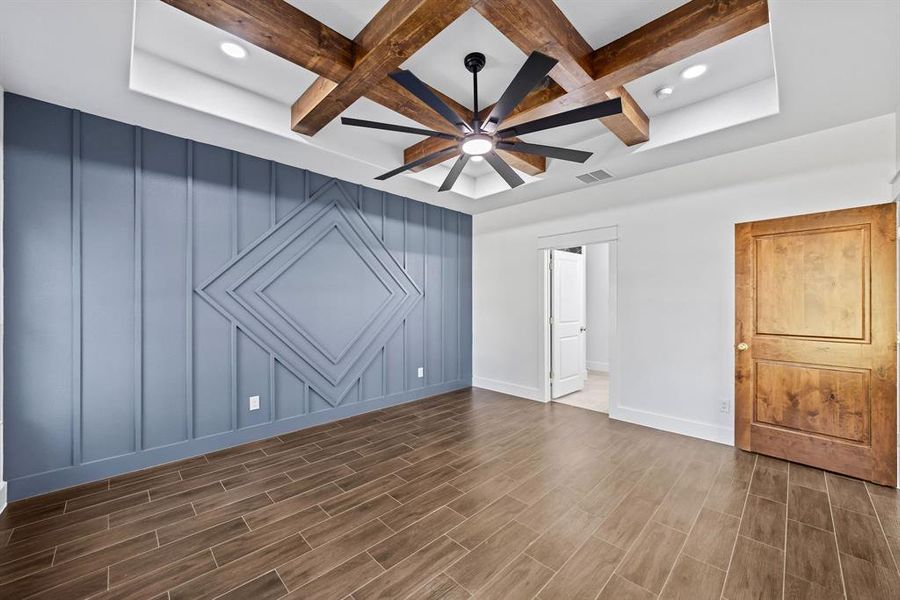 Unfurnished bedroom with coffered ceiling, beamed ceiling, a ceiling fan, wood tiled floors, and recessed lighting Unfurnished bedroom with coffered ceiling, beamed ceiling, a ceiling fan, wood tiled floors, and recessed lighting