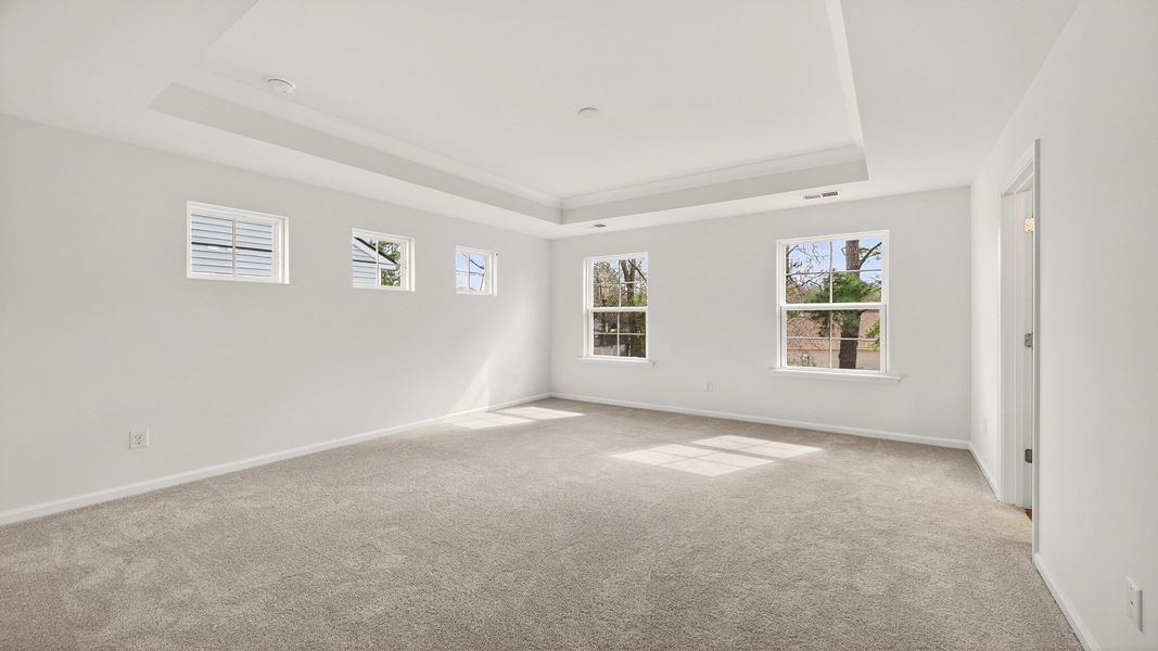 Relax in the bright and airy primary suite of the Pritchard