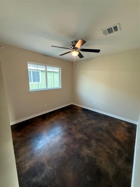 Spare room with concrete flooring and ceiling fan Spare room with concrete flooring and ceiling fan