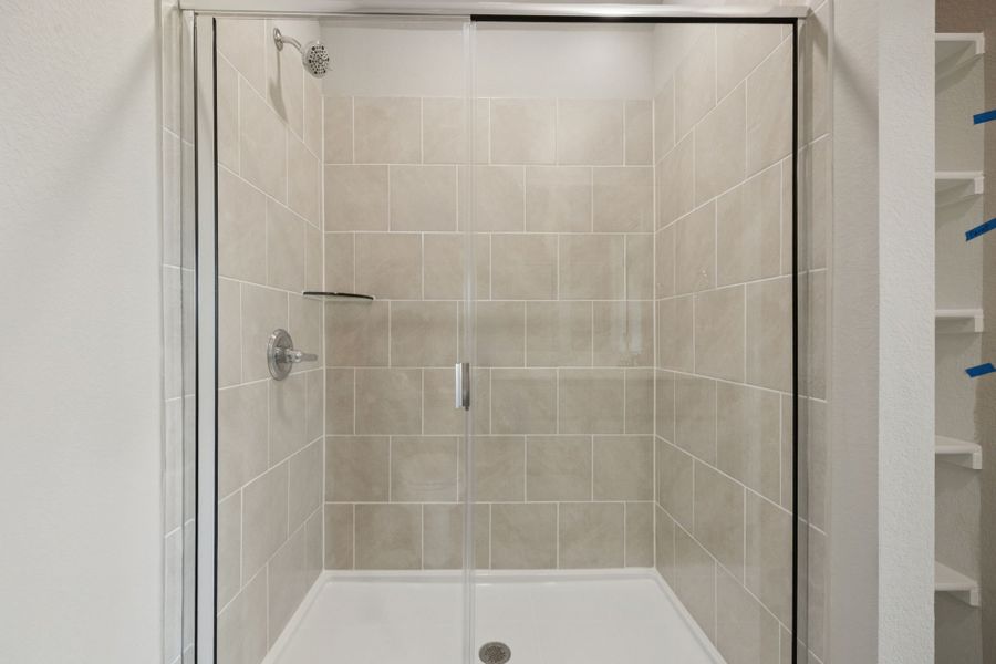 Primary Bathroom in the Pine home plan by Trophy Signature Homes - REPRESENTATIVE PHOTO