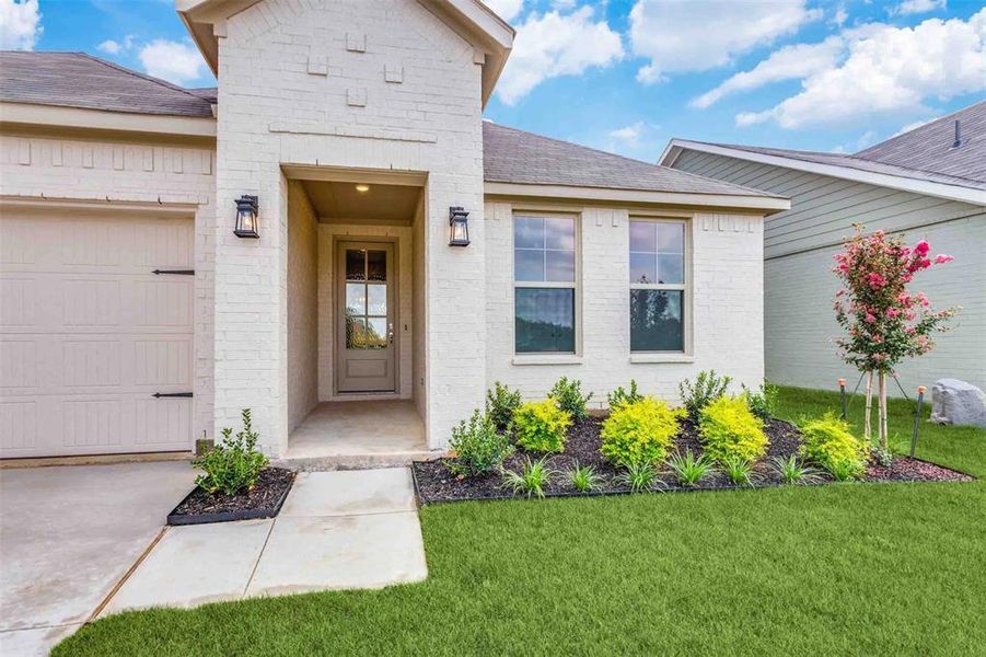 Doorway to property with a yard