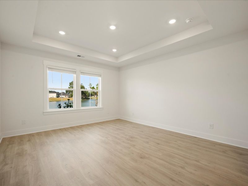 Spacious, unfurnished interior of a new home in The Coves at Lakes of Cane Bay, Summerville (Image 19).