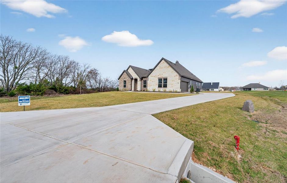 Front exterior of a new home in Nash Estates, Tom Bean, TX, highlighting curb appeal (Image 26).