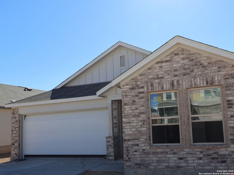 Front exterior of a new home in Hunters Ranch, San Antonio, TX, highlighting curb appeal (Image 21). Front exterior of a new home in Hunters Ranch, San Antonio, TX, highlighting curb appeal (Image 21).