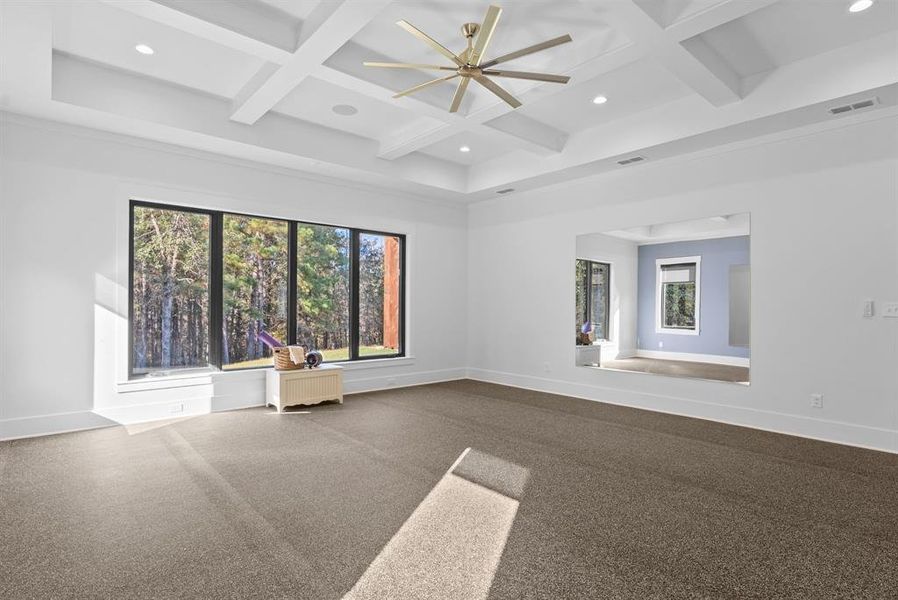 Spare room with coffered ceiling, recessed lighting, beam ceiling, and radiator heating unit