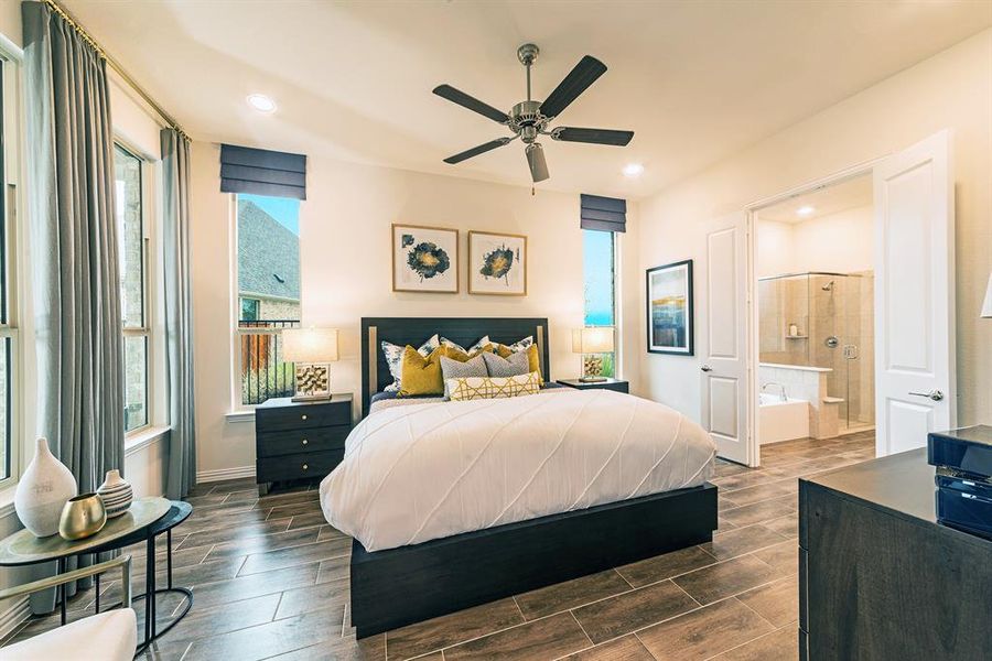 Bedroom featuring wood tiled floors, a ceiling fan, recessed lighting, and ensuite bath