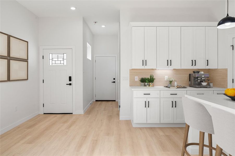 Upon entering, you’re welcomed by a bright, open entry that flows seamlessly into the main living area. Features include high ceilings, recessed lighting, wood-look flooring, a modern staircase with contrasting treads, and an open-concept layout designed for both comfort and functionality. *Virtually Staged Upon entering, you’re welcomed by a bright, open entry that flows seamlessly into the main living area. Features include high ceilings, recessed lighting, wood-look flooring, a modern staircase with contrasting treads, and an open-concept layout designed for both comfort and functionality. *Virtually Staged