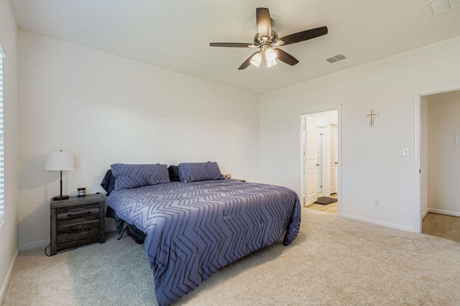 Bedroom featuring light carpet and ceiling fan