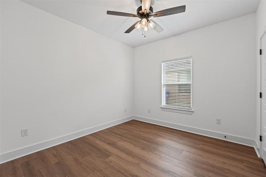This room features hard surface flooring, a window with blinds, and a ceiling fan