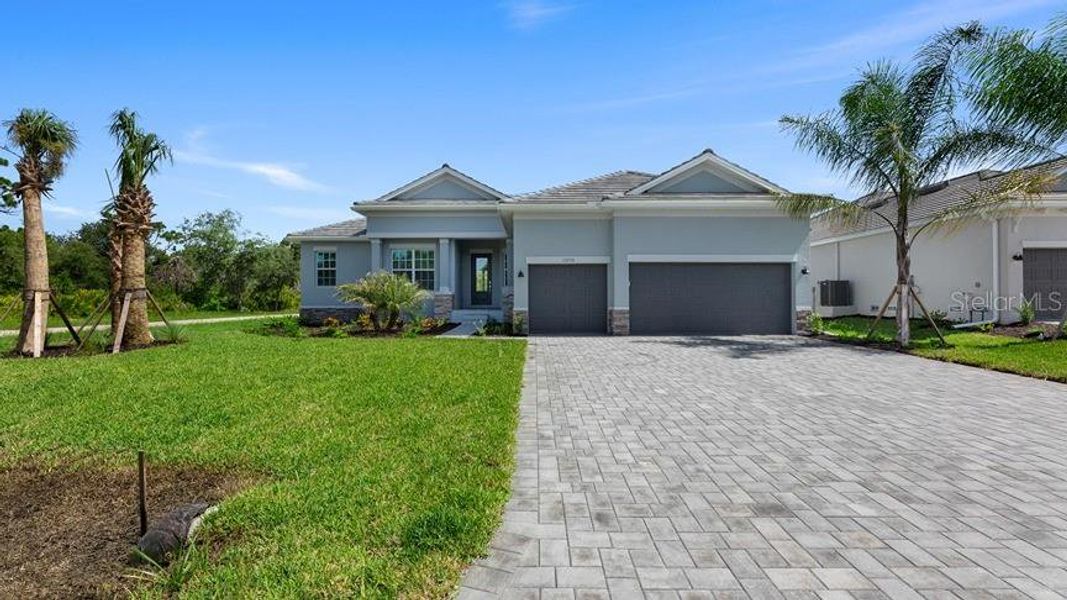 Front exterior of a new home in South Gulf Cove, Port Charlotte, FL, highlighting curb appeal (Image 1).
