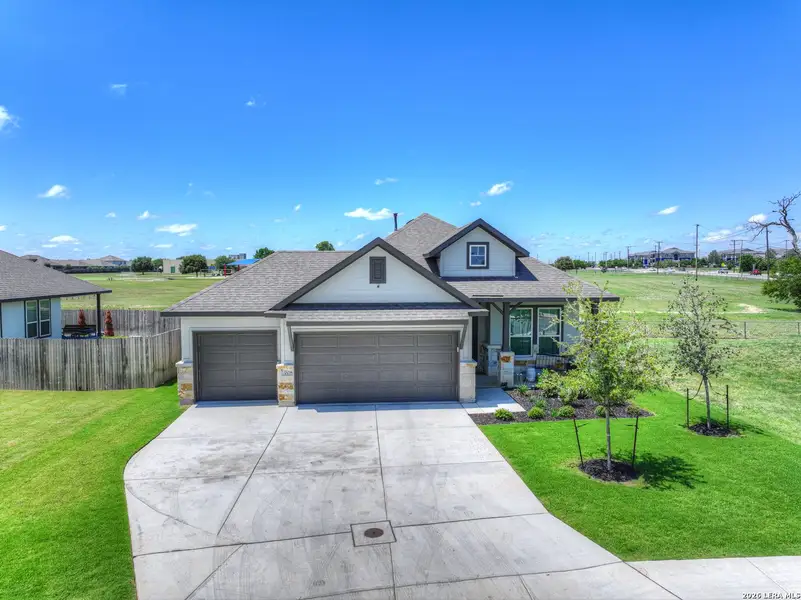 Front exterior of a new home in August Fields, New Braunfels, TX, highlighting curb appeal (Image 21).
