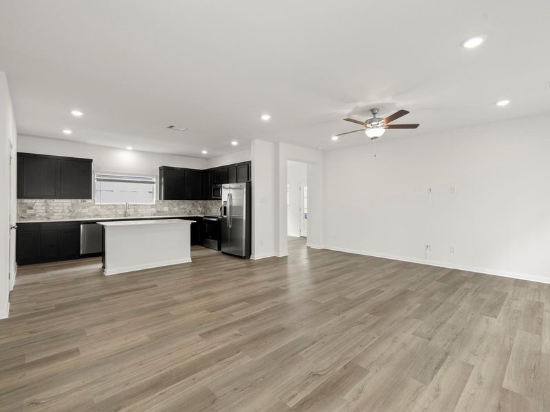 An open concept design seamlessly connects a modern kitchen to a generous living area, ideal for entertaining.