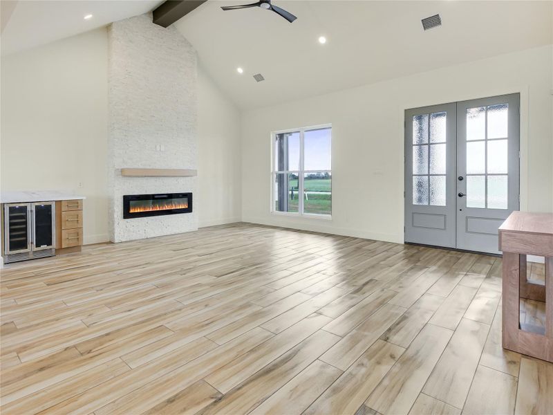 Double door, porcelain tile flooring throughout, Fireplace with marble walls, Beverage bar.