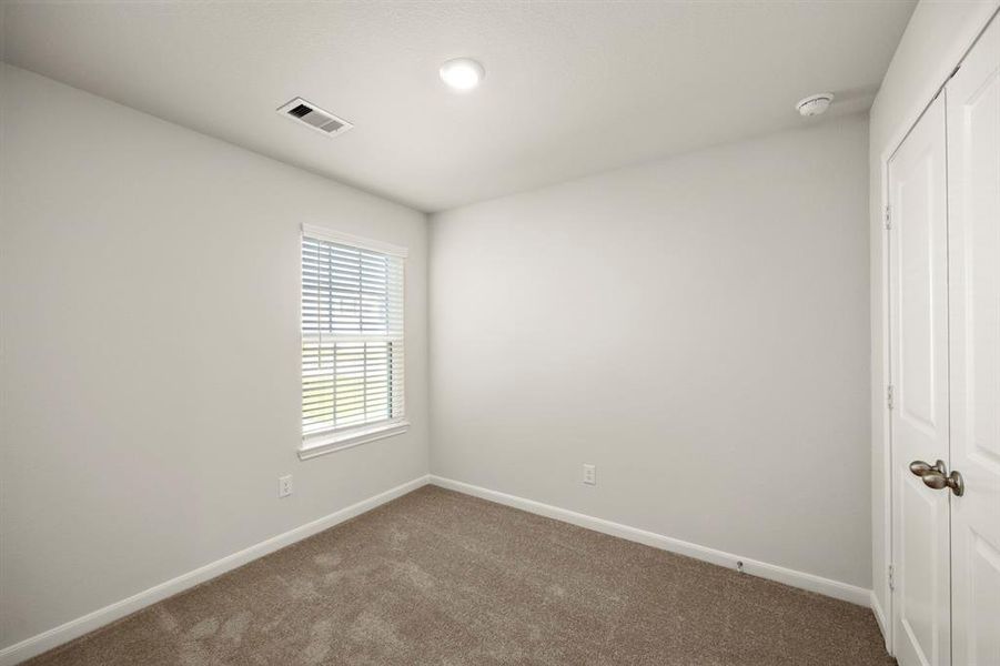 One of the two additional bedrooms in the home.