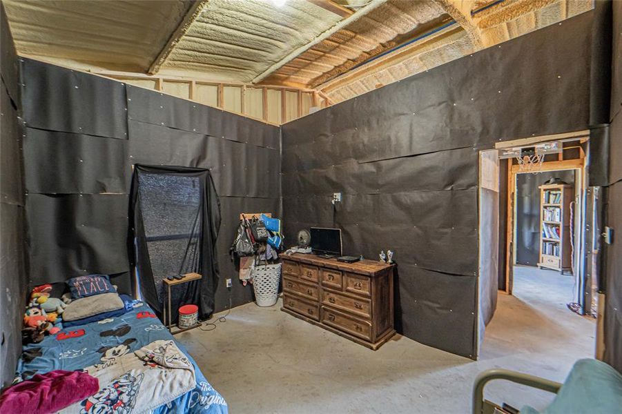 Bedroom featuring unfinished concrete floors