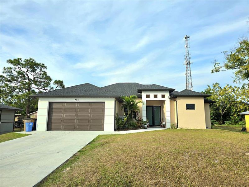 Front exterior of a new home in , Lehigh Acres, FL, highlighting curb appeal (Image 20).