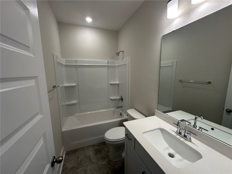 This clean and functional bathroom features a show
