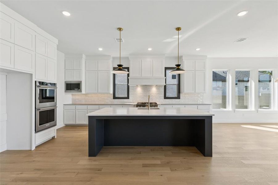 The oversized kitchen island is the hub of your new dream kitchen and the perfect place for friends and family to gather.